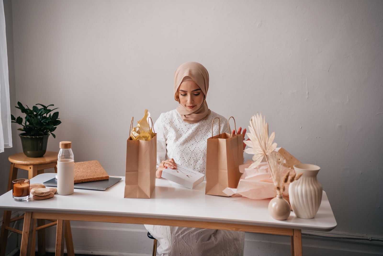A Muslim woman packing online orders